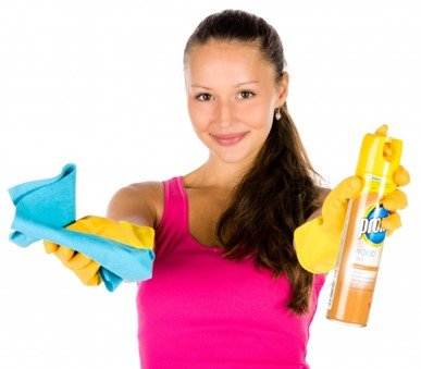 A woman holding a cleaning spray