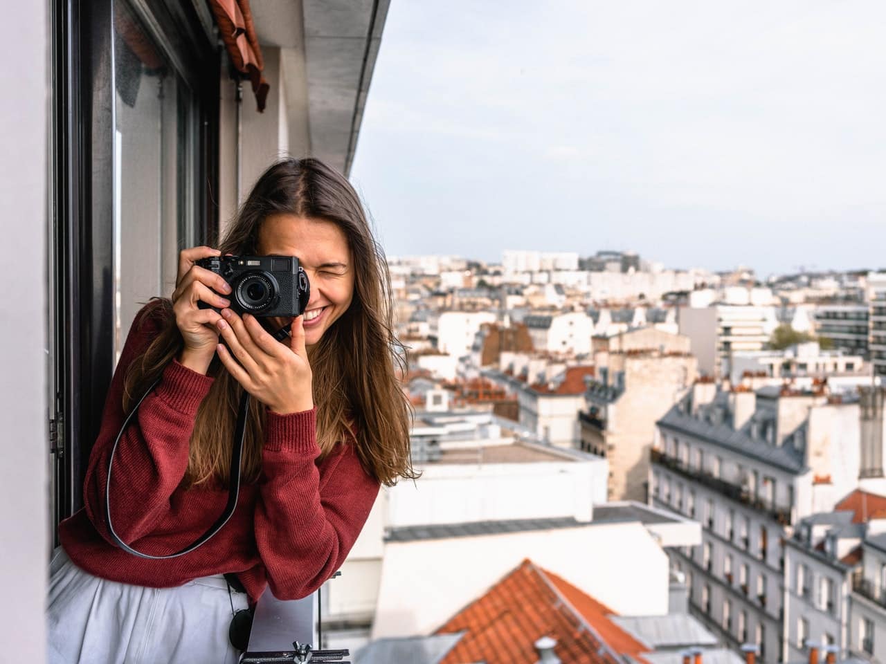Girl Smiling While Taking a Picture in the Balcony