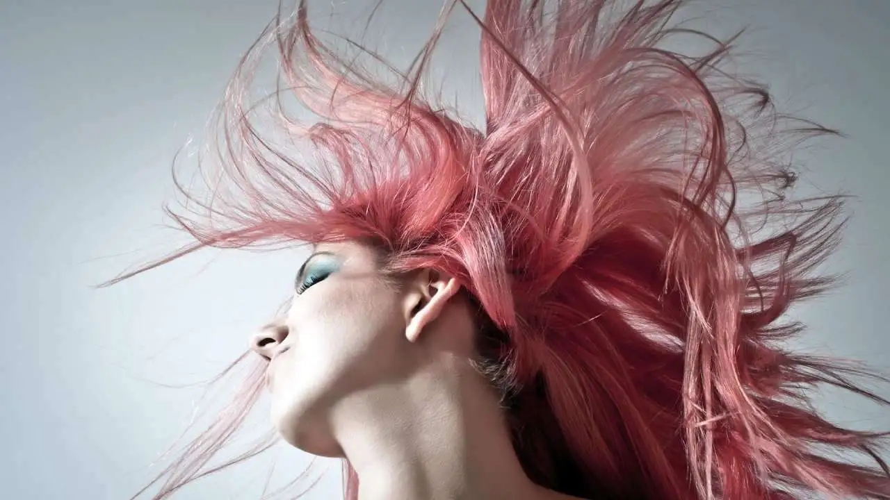 A woman with pink hair colour