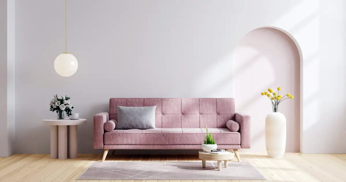 A grey and pink living room with a sofa