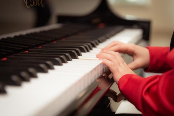 A boy playing a piano