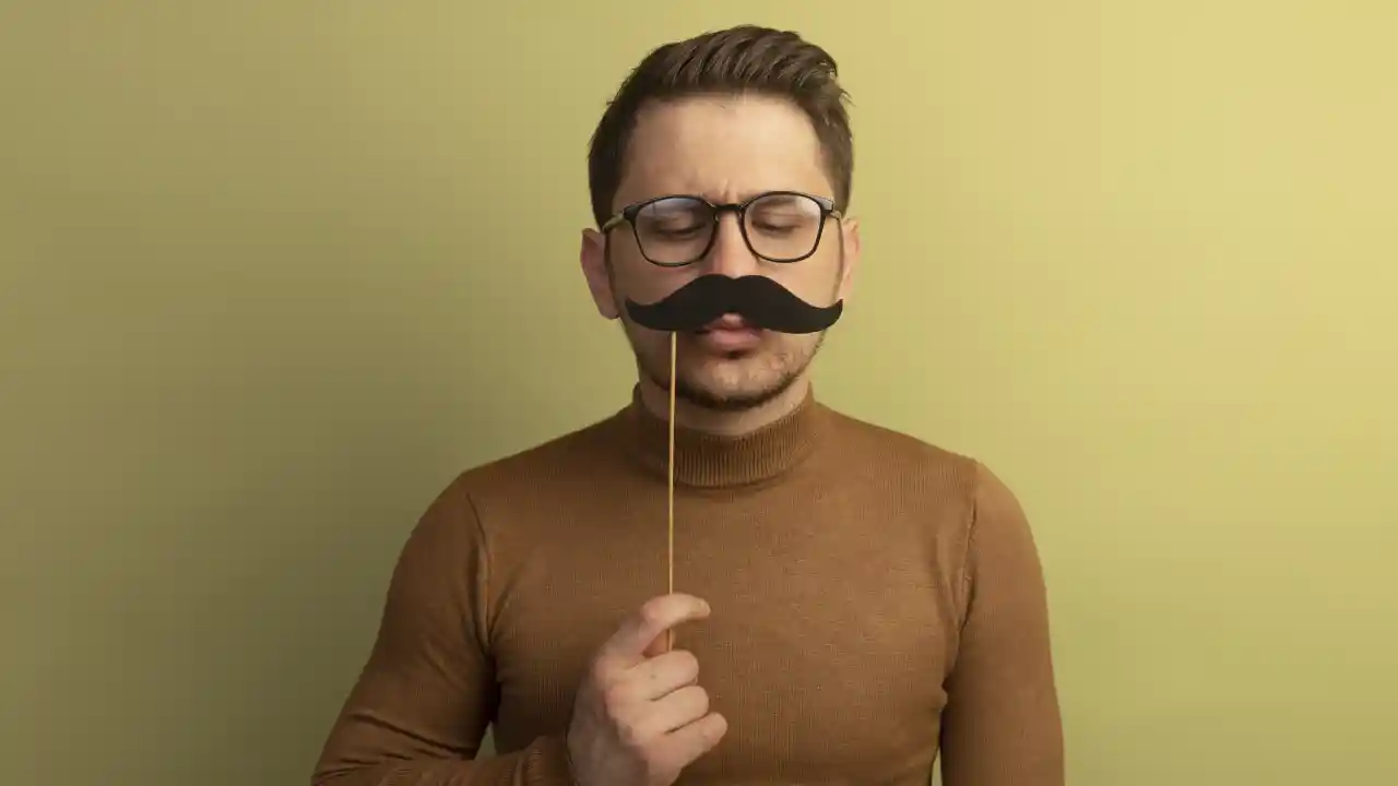 A man holding a moustache
